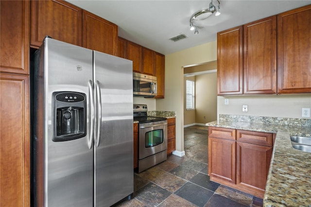 kitchen featuring light stone counters and stainless steel appliances