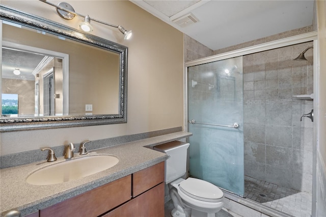 bathroom with vanity, crown molding, toilet, and walk in shower