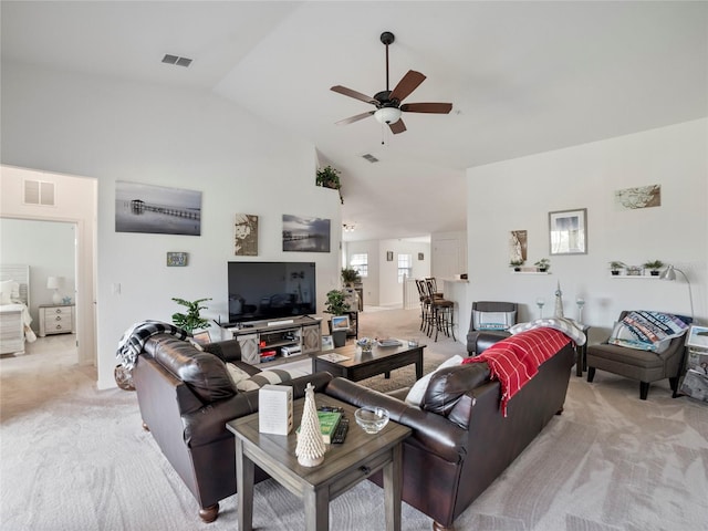 carpeted living room featuring ceiling fan and high vaulted ceiling