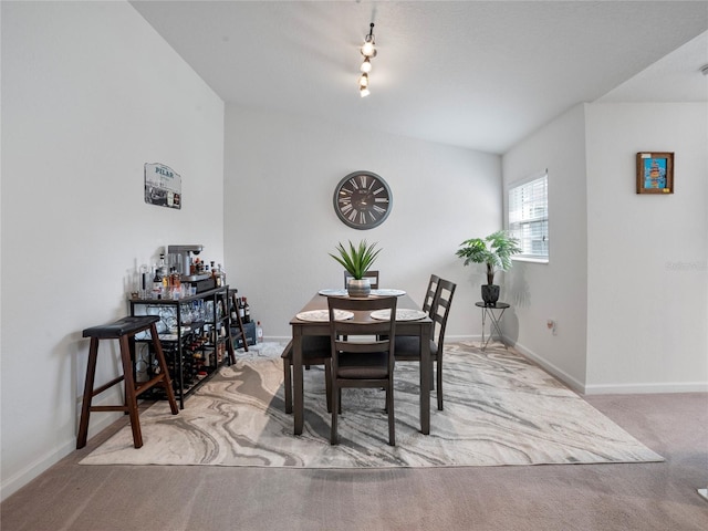 dining space featuring light carpet