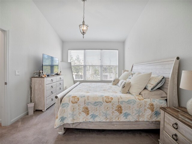 carpeted bedroom featuring vaulted ceiling