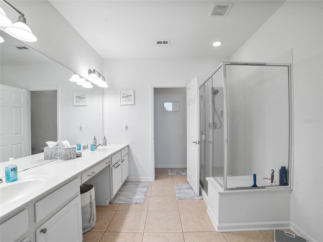 bathroom featuring vanity, a shower with shower door, and tile patterned flooring