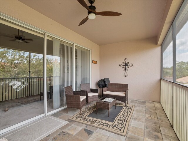 sunroom / solarium featuring ceiling fan