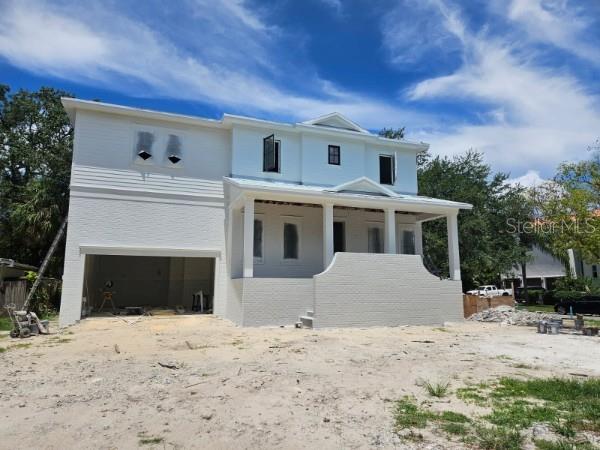 610 Ontario Ave, Tampa, FL 33606 - view of front of property with an attached garage, stucco siding, and driveway