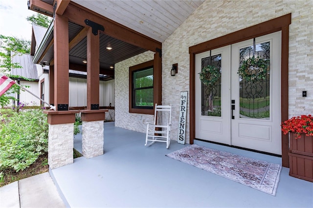 view of exterior entry featuring covered porch