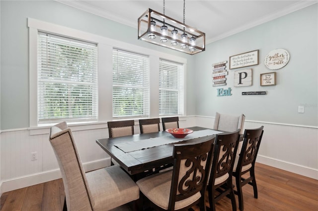 dining space with hardwood / wood-style flooring and ornamental molding