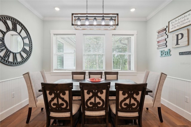 dining area with hardwood / wood-style floors and ornamental molding