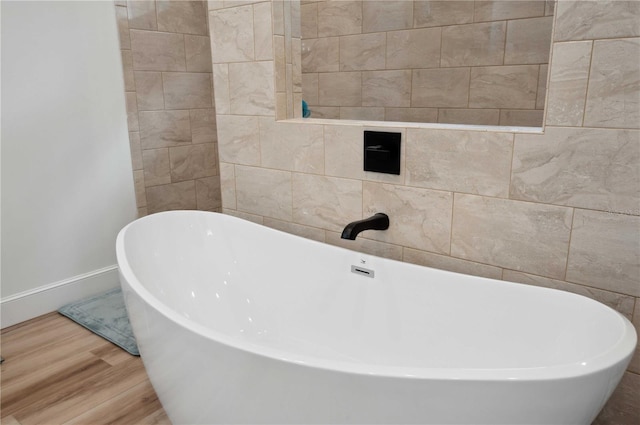 bathroom featuring a bathing tub and hardwood / wood-style flooring