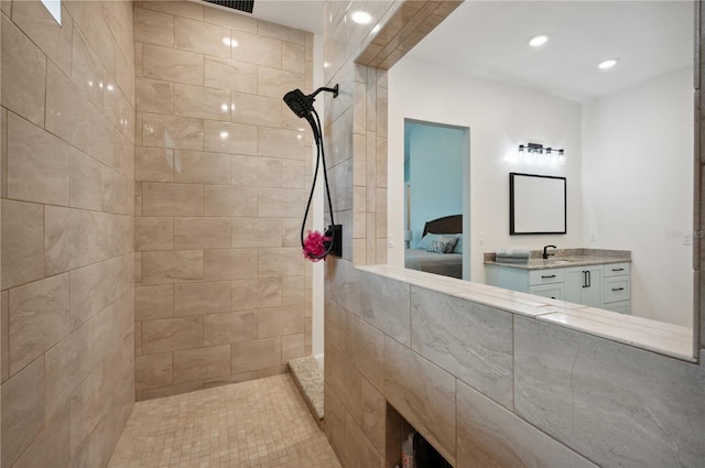 bathroom with vanity and tiled shower