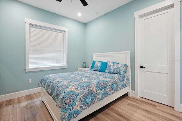 bedroom with light hardwood / wood-style floors and ceiling fan