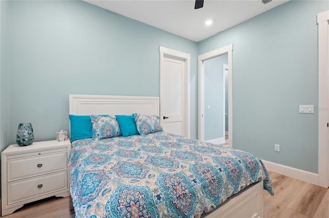 bedroom with ceiling fan and light hardwood / wood-style floors