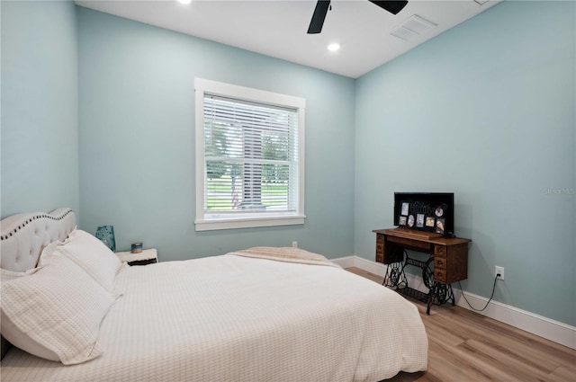 bedroom with ceiling fan and light hardwood / wood-style flooring