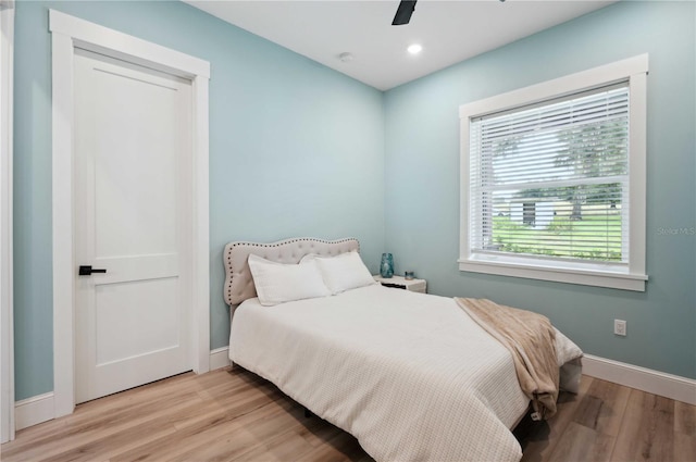 bedroom featuring light hardwood / wood-style flooring and ceiling fan