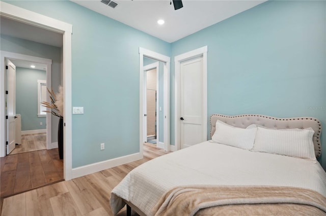 bedroom with light hardwood / wood-style flooring and ceiling fan