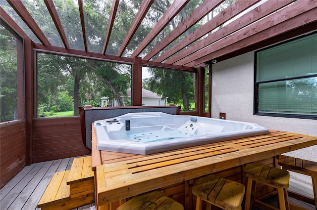 sunroom / solarium featuring a hot tub