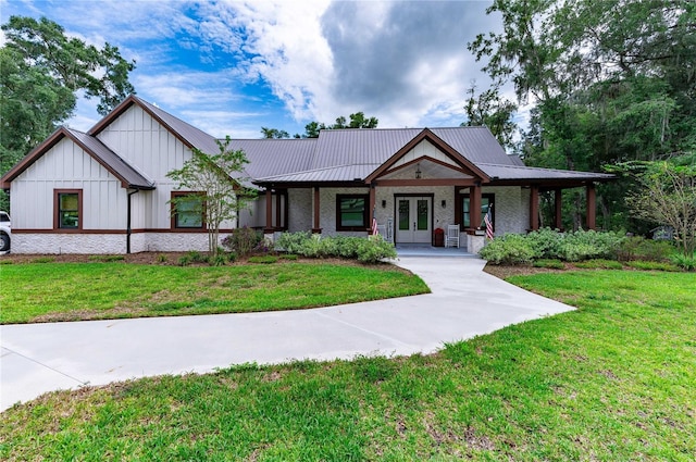 view of front facade featuring a front yard, central AC, and covered porch