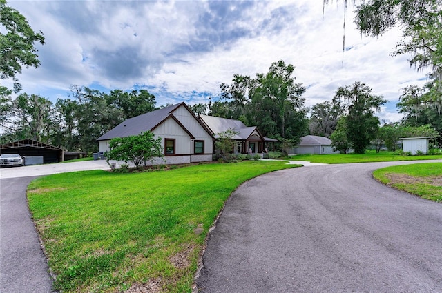 view of front of house with a carport, a garage, and a front lawn