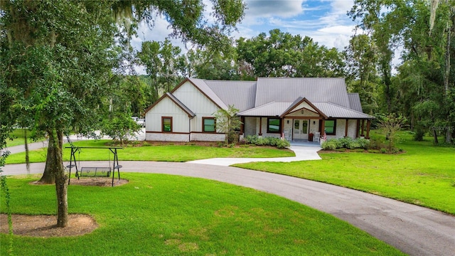 modern farmhouse style home with a front yard