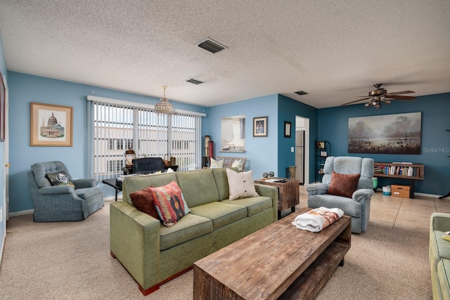 living room with a textured ceiling, ceiling fan, and light carpet