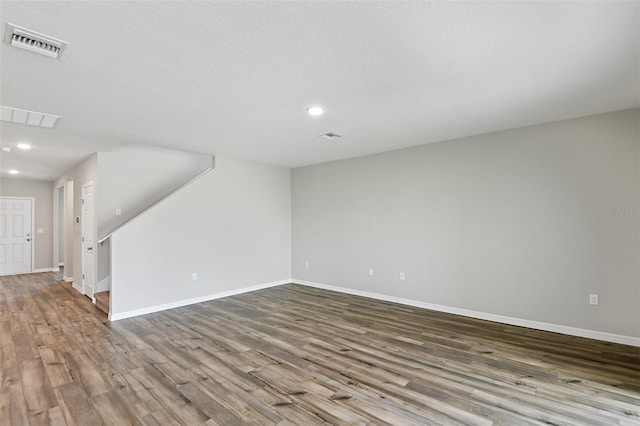 empty room featuring a textured ceiling and hardwood / wood-style floors