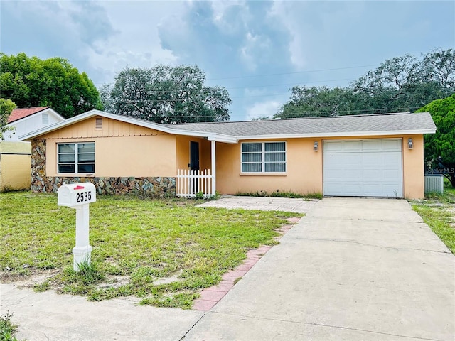 single story home featuring a garage and a front yard