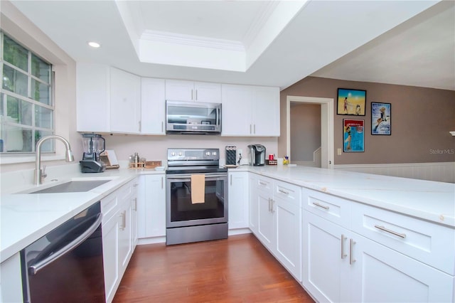 kitchen featuring sink, light stone countertops, appliances with stainless steel finishes, and white cabinets