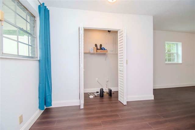 unfurnished bedroom with dark wood-type flooring and a closet