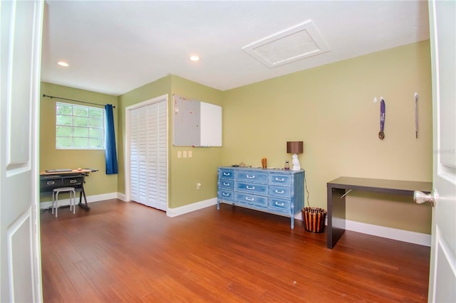 bedroom with a closet and dark hardwood / wood-style flooring