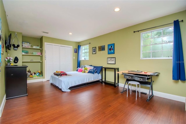 bedroom featuring dark hardwood / wood-style floors and a closet