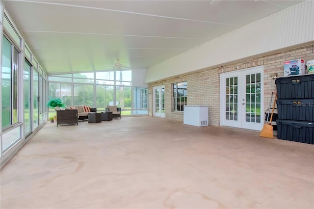 sunroom / solarium featuring ceiling fan, plenty of natural light, and french doors