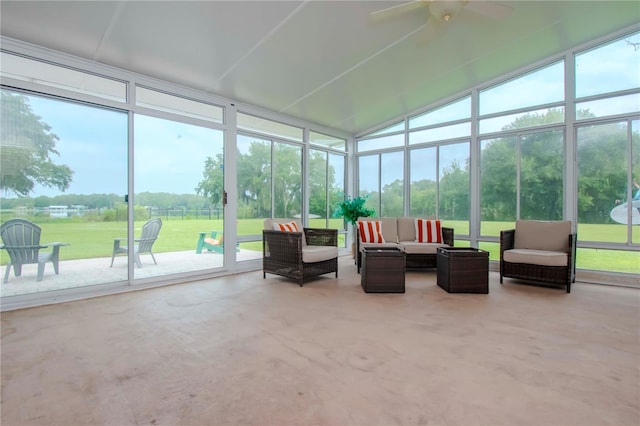 sunroom / solarium featuring ceiling fan