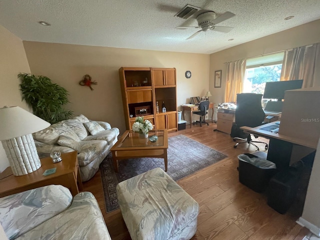 interior space with hardwood / wood-style floors, ceiling fan, and a textured ceiling