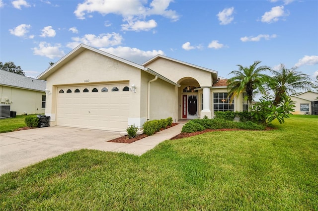 ranch-style home featuring cooling unit, a front yard, and a garage