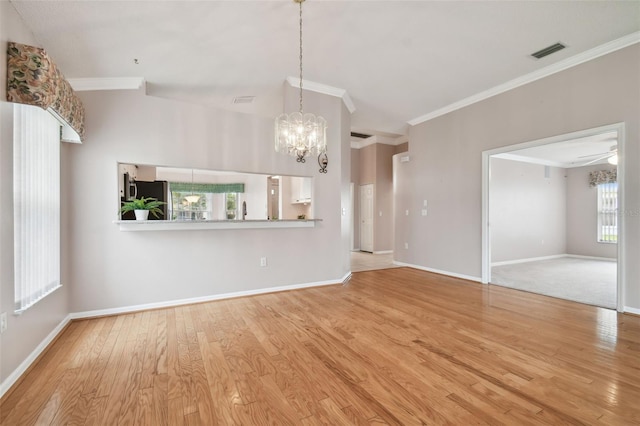 unfurnished living room featuring crown molding, ceiling fan with notable chandelier, and light wood-type flooring