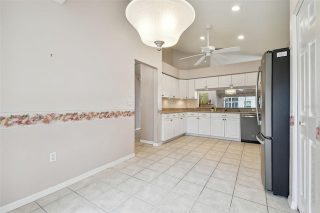 kitchen with white cabinets, sink, ceiling fan, light tile patterned floors, and stainless steel appliances