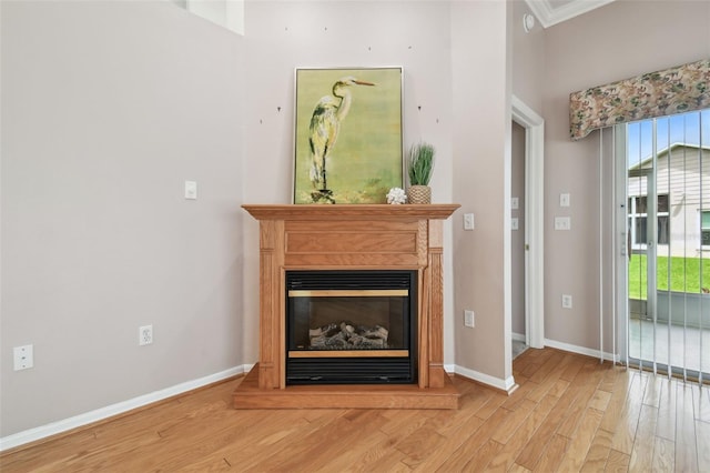 unfurnished living room featuring light hardwood / wood-style floors and ornamental molding