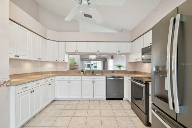 kitchen with appliances with stainless steel finishes, white cabinetry, ceiling fan, and sink