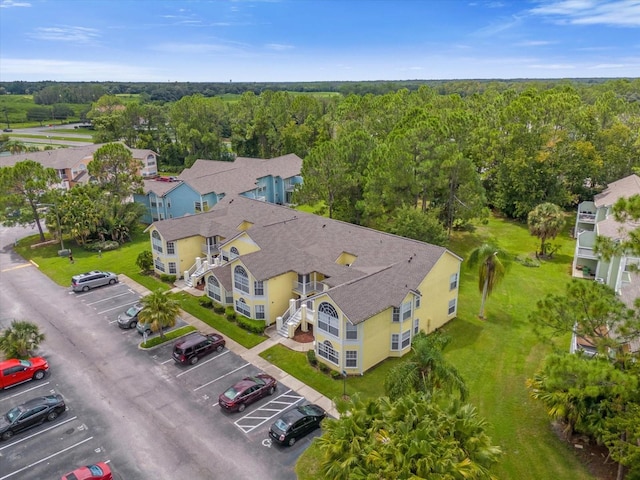 drone / aerial view featuring a wooded view