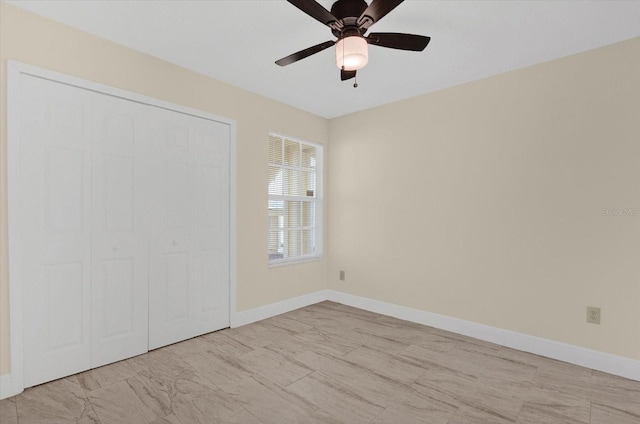 interior space featuring ceiling fan and baseboards