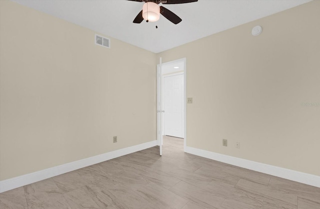 empty room with visible vents, ceiling fan, and baseboards