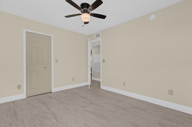 spare room featuring visible vents, baseboards, and a ceiling fan