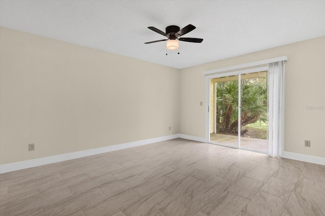 unfurnished room featuring baseboards and a ceiling fan