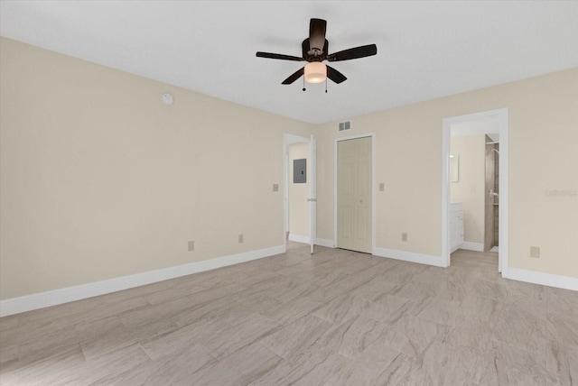 unfurnished bedroom with a ceiling fan, baseboards, visible vents, electric panel, and ensuite bathroom