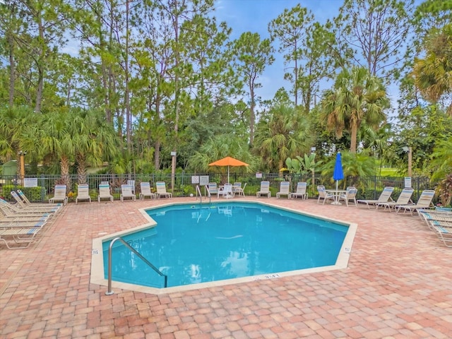 view of pool featuring a patio and fence