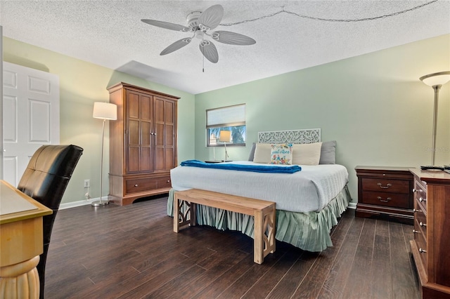 bedroom with dark wood-type flooring and a textured ceiling