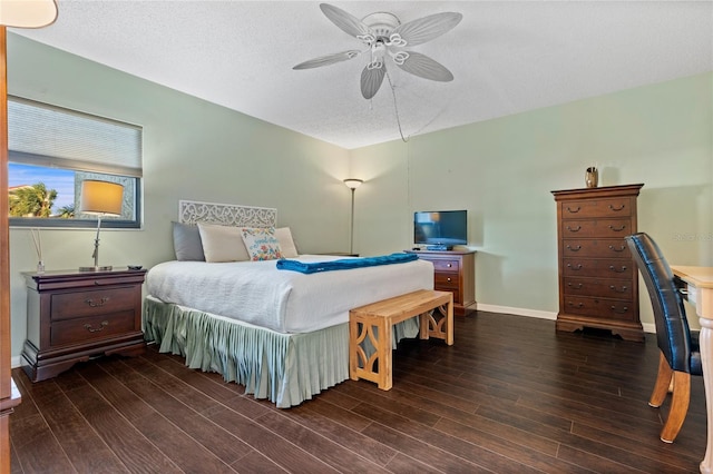 bedroom featuring a textured ceiling, ceiling fan, and dark hardwood / wood-style flooring