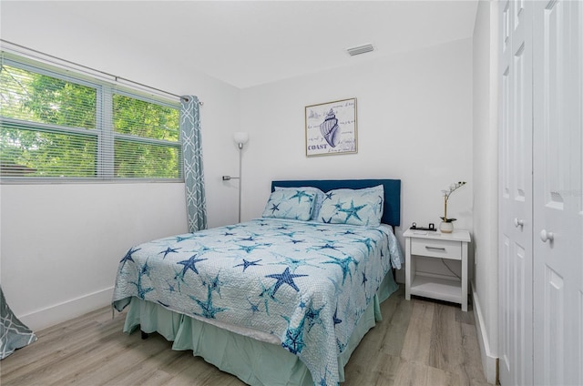 bedroom featuring light hardwood / wood-style flooring and a closet