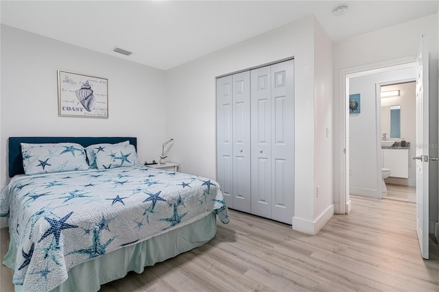 bedroom featuring a closet and light hardwood / wood-style flooring