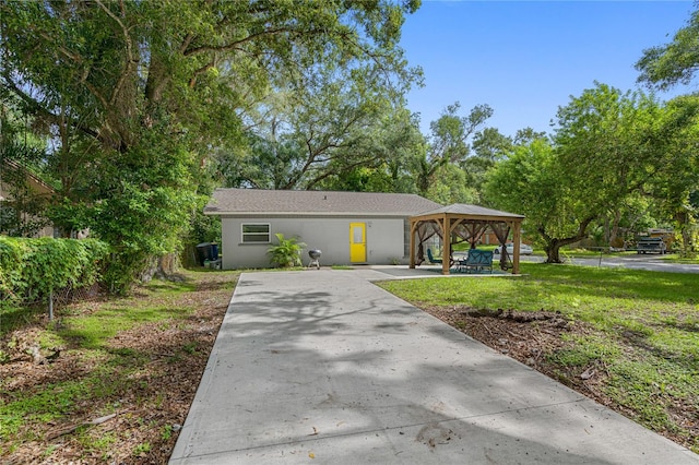 view of front of home featuring a gazebo and a front lawn