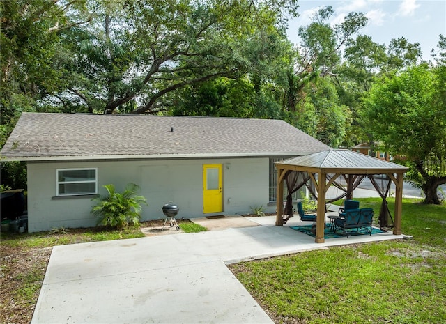 exterior space with a gazebo, a patio, and a front yard